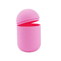 Light pink silicone steriliser with lid partially open, hinged top section