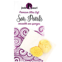 Three yellow sea sponge pearls placed on a white product card