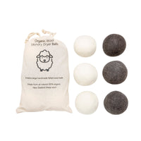 Organic wool dryer balls set in a cotton bag, light and dark felt balls